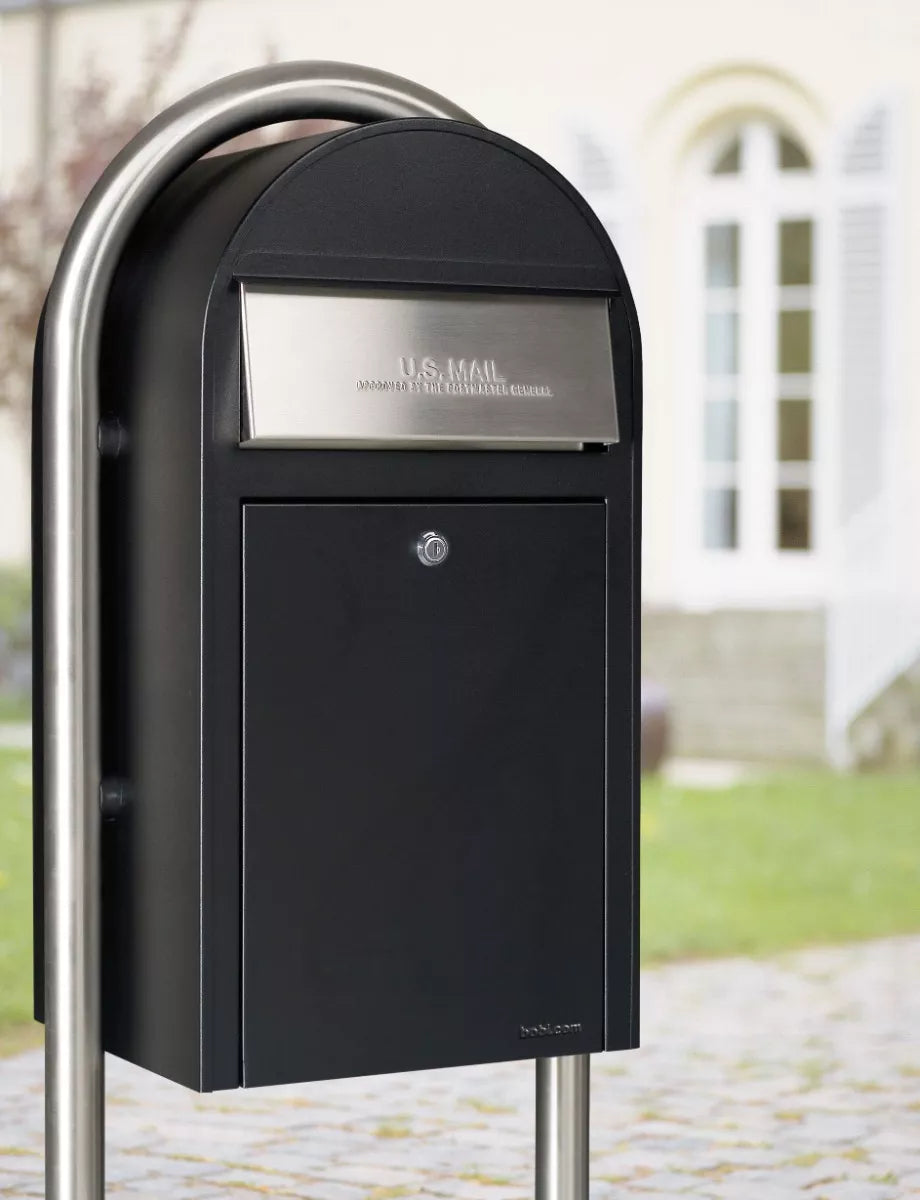 Bobi mailbox with stainless steel post, digitally edited in front of a house for reference.